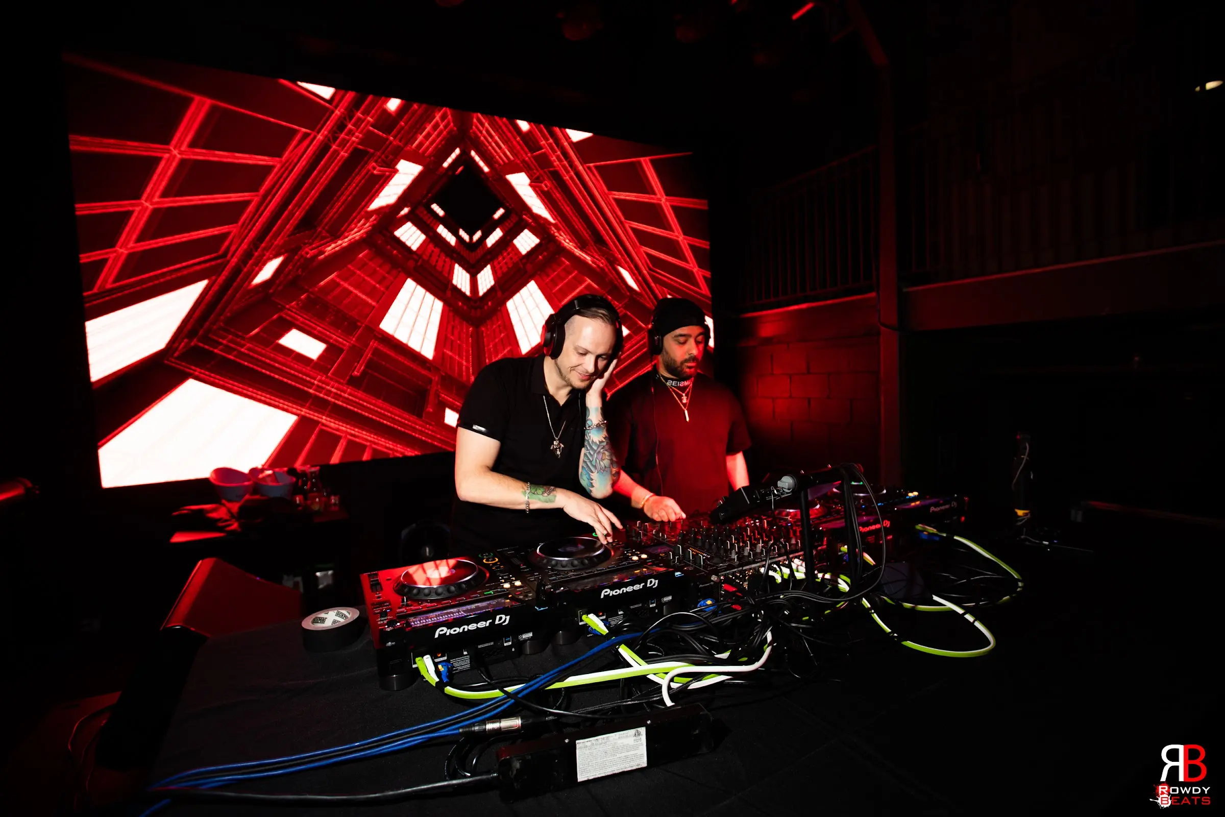 Shane V mixing beneath red stage visuals